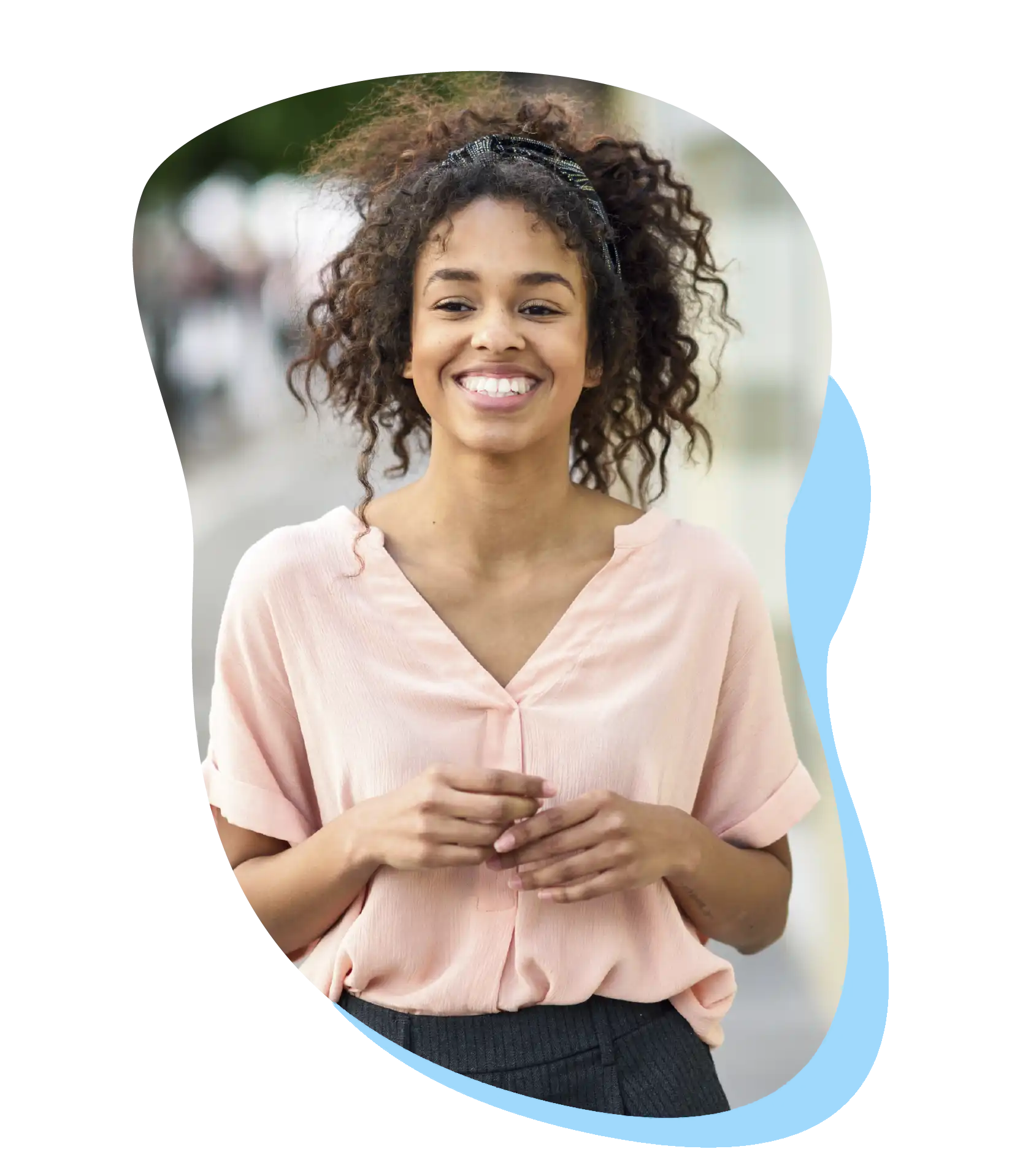Smiling woman standing comfortably after a pregnancy test at First Care Women’s Health.
