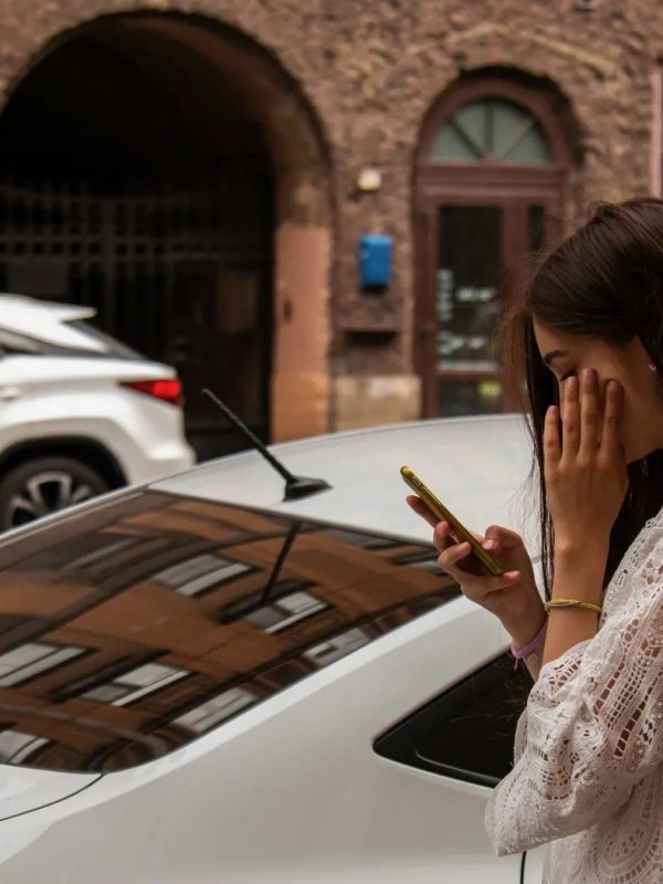 Young woman reading phone with concern